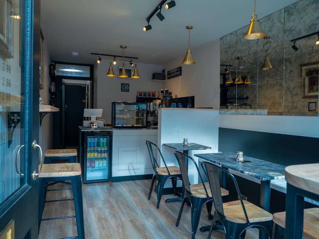 Inside South Street Coffee Co, Emsworth, with bar seating and a display counter