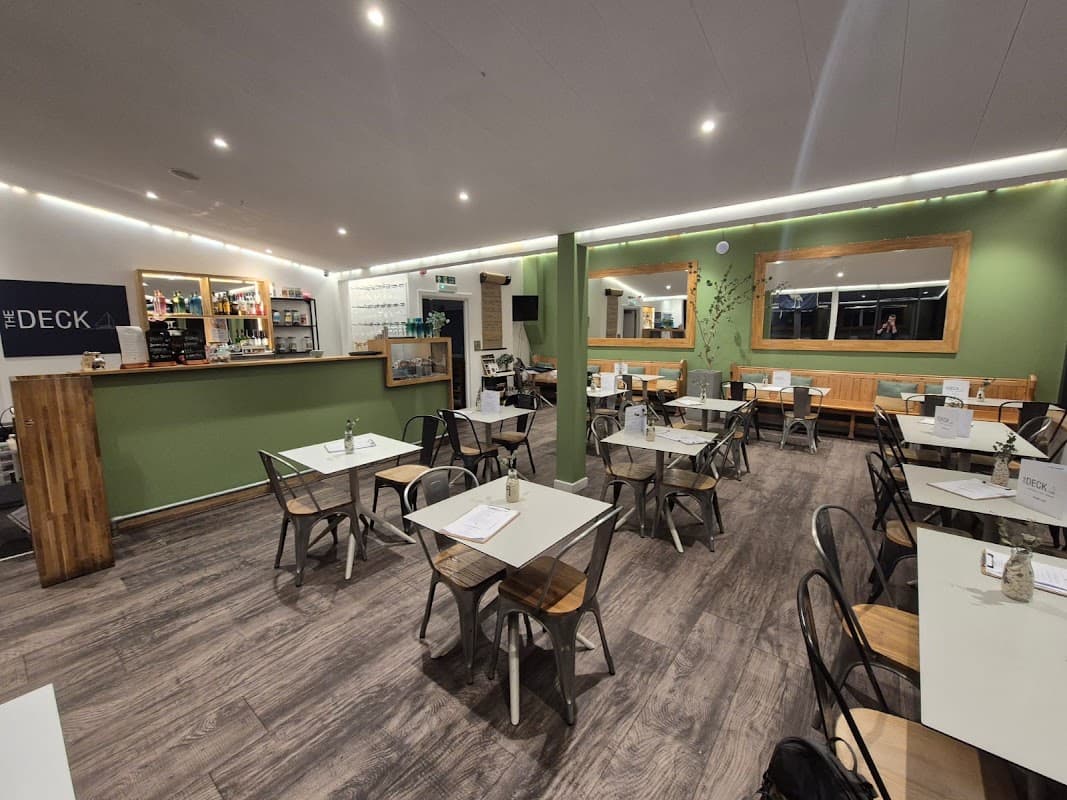 The dining room at The Deck Emsworth, with bar seating and marina-view windows